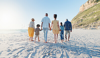 Buy stock photo Holding hands, walking and big family at the beach on holiday, adventure or vacation together. Love, travel and children with parents and grandparents on the sand by the ocean or sea on weekend trip.