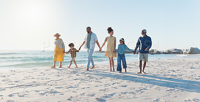 Buy stock photo Holding hands, walking and big family at the beach on vacation, adventure or holiday together. Love, travel and children with parents and grandparents on the sand by the ocean or sea on weekend trip.