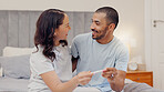 Excited couple, bed and positive pregnancy test for family, start or maternity at home. Face of happy man and pregnant woman smile for parenthood, morning or good news or results in bedroom together
