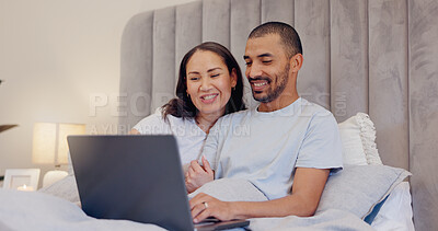 Buy stock photo Laptop, smile and young couple in bed watching movie, film or show together at home. Happy, technology and man and woman relaxing in bedroom streaming a video on computer for bonding at modern house.