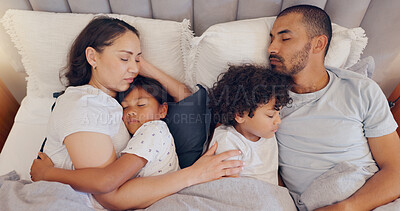 Buy stock photo Tired, sleeping and parents with children in bed on a weekend morning in modern family home. Exhausted, cuddle and young mother and father taking a nap and dreaming with kids in bedroom at house.