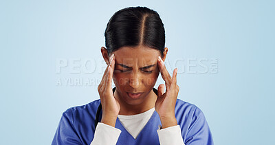 Doctor, studio or woman with headache, emergency or fatigue in medical healthcare crisis or head pain. Depression, face or tired nurse with burnout, migraine or stress isolated on blue background