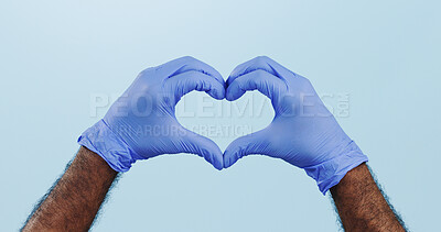 Buy stock photo Man, doctor and heart hands with gloves for healthcare isolated against a blue studio background. Closeup of male person or medical nurse with like emoji, yes sign or shape for love or care on mockup