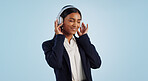 Headphones, studio or happy businesswoman listening to music isolated on blue background. Dance, smile or calm female person streaming a radio song, sound or audio on online subscription to relax 