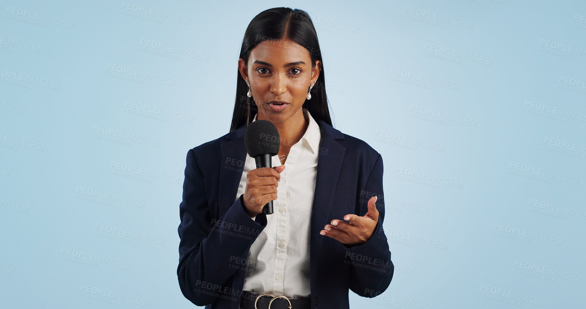 Buy stock photo Woman, portrait or presenter in studio talking, speaking on talk show or media on blue background. Breaking news, tv press or Indian reporter presenting live global political events with microphone