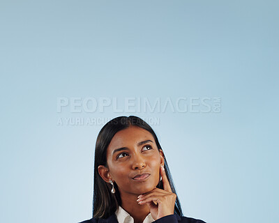 Buy stock photo Thinking space, solution or businesswoman in studio for problem solving on blue background. Ideas, doubt or decision with an Indian attorney or lawyer contemplating a thought, choice or legal option