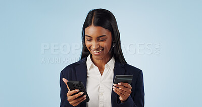 Buy stock photo Happy business woman, phone and credit card for payment or online shopping against a blue studio background. Female person or employee smile with mobile smartphone in banking or transaction on mockup