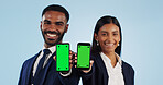 Business people, portrait and phone with green screen for advertising against a blue studio background. Businessman and woman employee showing mobile smartphone display, chromakey or mockup space