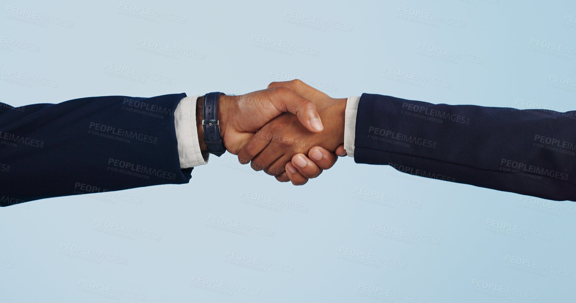 Buy stock photo Business people, handshake and meeting for partnership, deal or agreement against a blue studio background. Closeup of employees shaking hands for b2b, introduction or thank you on mockup space