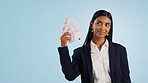 Happy business woman, thinking and money fan in financial freedom against a blue studio background. Female person or employee in thought or wonder with cash, savings or investment on mockup space