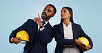 Business people, architect and pointing in vision for building or construction against a blue studio background. Man and woman in engineering or project plan with hard hat for safety on mockup space