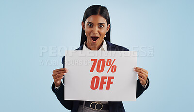 Buy stock photo Happy woman, portrait and sale sign for advertising, discount or deal against a blue studio background. Female person with billboard or poster for marketing, promotion or special on mockup space