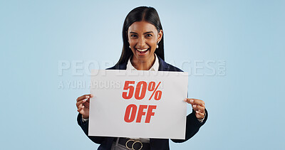 Buy stock photo Happy woman, portrait and sign for advertising discount, deal or half price against a blue studio background. Female person with billboard or poster in marketing, promotion or special on mockup space