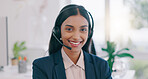 Happy woman, portrait and headphones in call center for customer service or support at office. Face of friendly Indian female person, consultant or agent smile for online advice or help at workplace