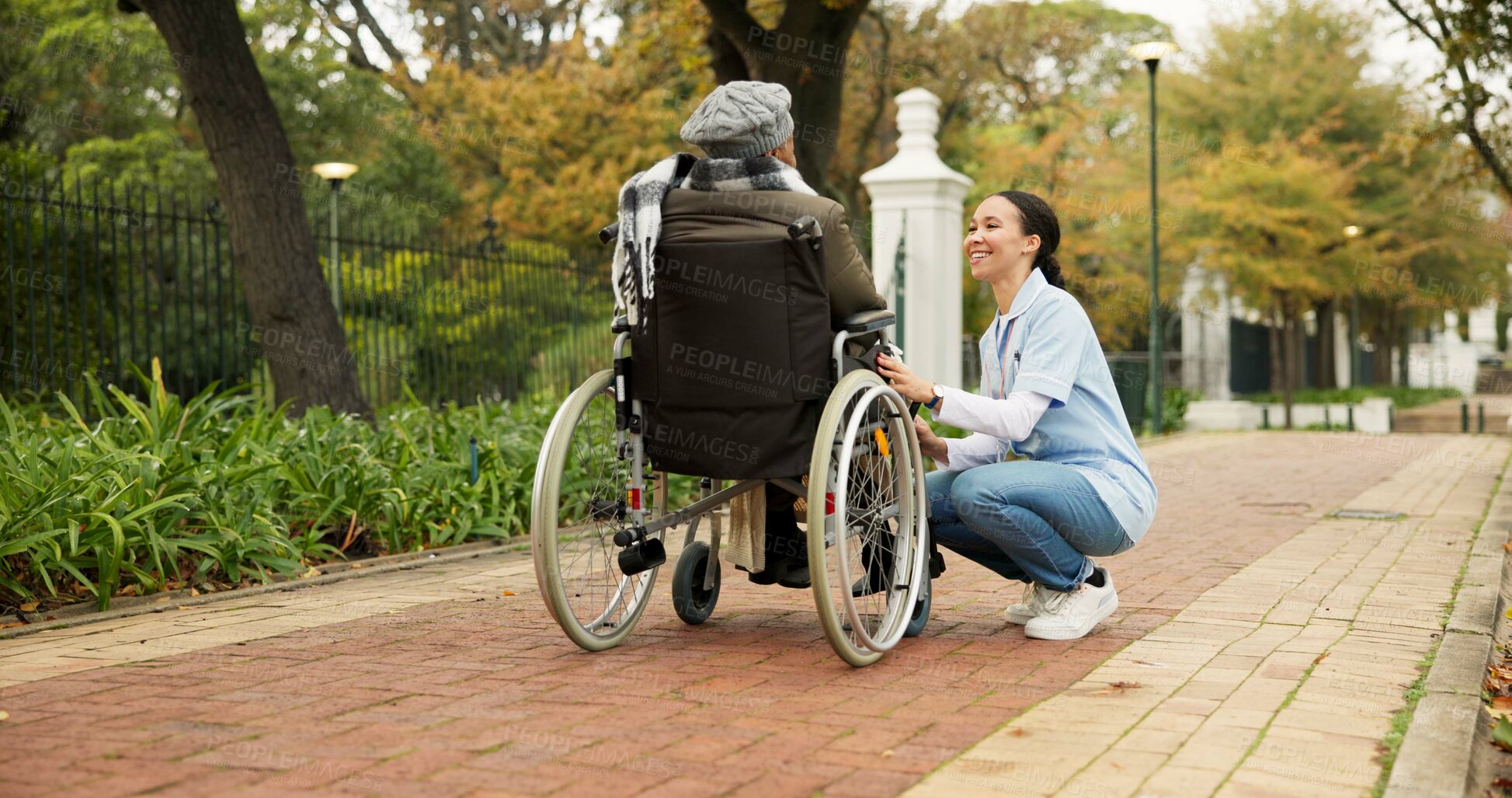 Buy stock photo Nurse, relax and park with old woman in a wheelchair for retirement, elderly care and physical therapy. Trust, medical and healthcare with senior patient and caregiver in nature for rehabilitation