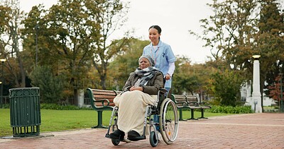Nurse, walking and park with old woman in a wheelchair for retirement, elderly care and physical therapy. Trust, medical and healthcare with senior patient and caregiver in nature for rehabilitation