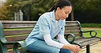 Sad, tired and nurse with woman on park bench for thinking, fatigue and burnout. Mental health, anxiety and depression with female person in nature for frustrated, exhausted and healthcare problem