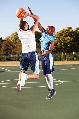 Buy stock photo Basketball, training and men jump on court in game with ball, workout and outdoor exercise in sports. Fitness, competition and athlete shooting for a goal, challenge or stretching to score in match