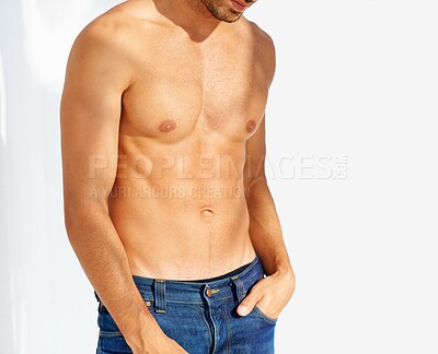 Buy stock photo Fashion, tattoo and shirtless with a man outdoor on a white background for edgy or unique style. Health, fitness and denim jeans with the body of a model in the sunlight for masculine or macho style