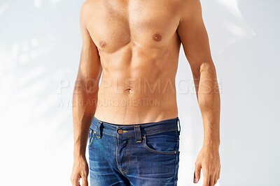 Buy stock photo Fashion, tattoo and body with a man outdoor on a white background for edgy or unique style. Health, fitness and denim jeans with a shirtless model in the sunlight for masculine or macho style