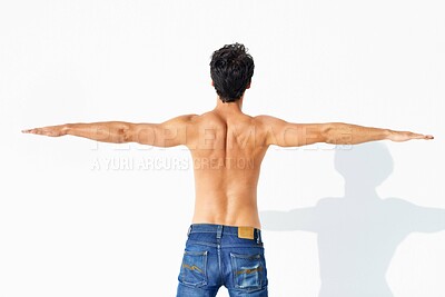 Buy stock photo Back, muscle and shirtless with man, stretching and promotion isolated on a white studio background. Person, guy and model with exercise, jeans or fitness with health, mockup space and body with care