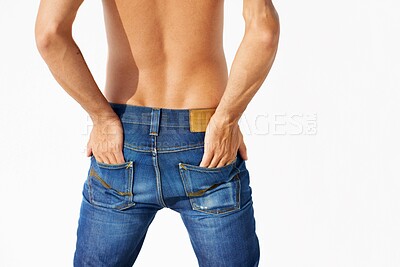 Buy stock photo Jeans, back and a man in studio with hands in pocket for pose, clothes and denim. Male fashion model person posing shirtless isolated on a white background for style, sports body and designer wear