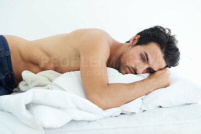 Buy stock photo Sad, young man in bed and depressed in bedroom in white background. Sleeping for mental health, insomnia and shirtless male person resting for peace or comfort on mattress in studio backdrop
