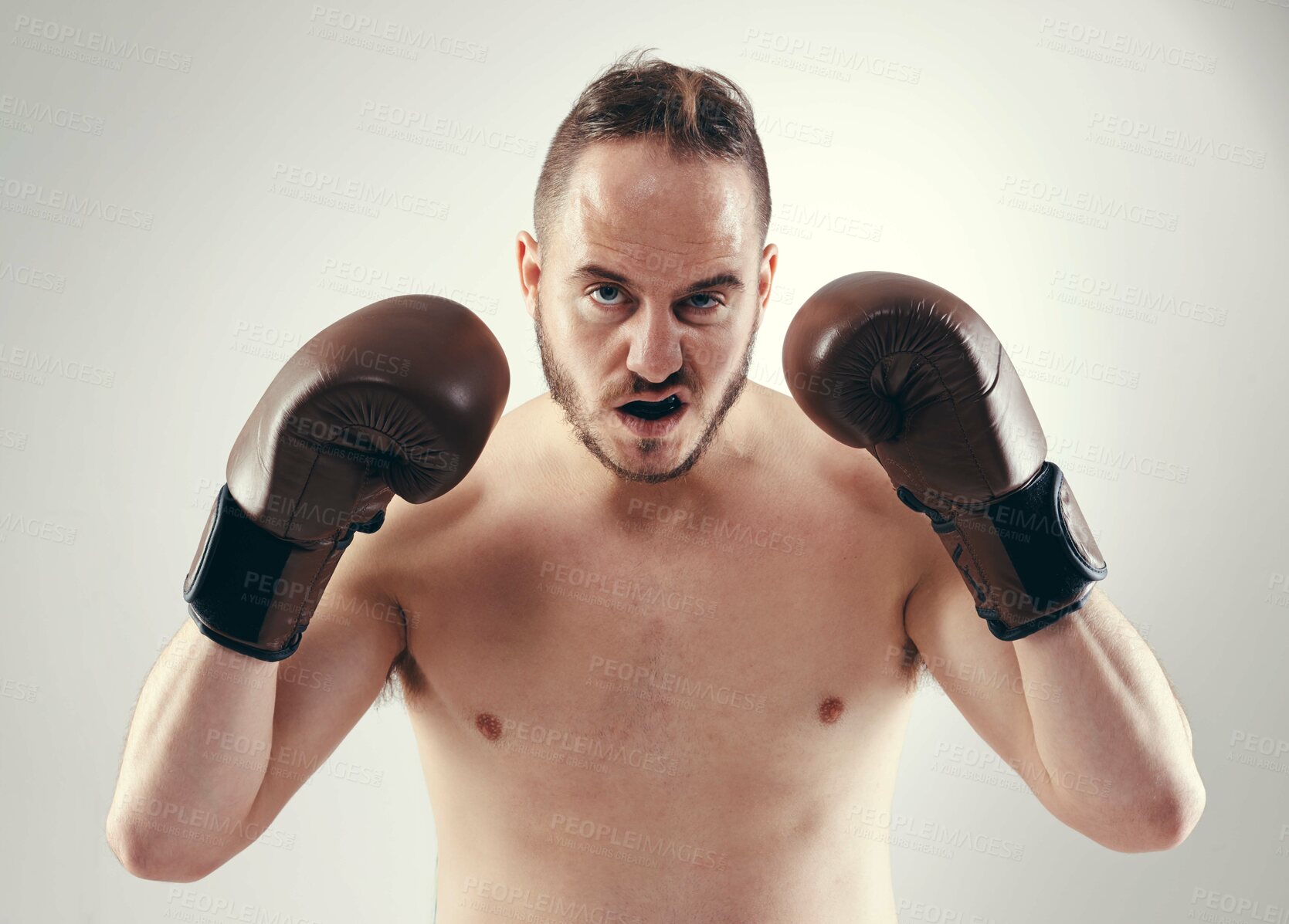 Buy stock photo Cropped shot of a serious MMA fighter standing isolated on white