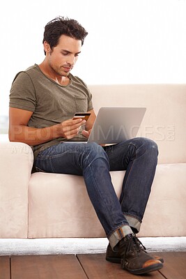 Buy stock photo Credit card, laptop and man on sofa for online shopping, e commerce and digital payment on fintech software. Person on couch, typing on computer and internet banking for financial investment or sale