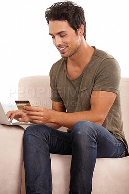 Buy stock photo Credit card, computer and man on sofa for online shopping, e commerce and digital payment and home fintech. Person on couch, typing on laptop and internet banking for financial investment or sale