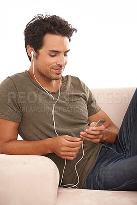 Buy stock photo Man, music player or earphones on sofa and podcast or radio streaming for break in living room of home. Person, face or listening with technology on couch in lounge for sound, song or audio in house