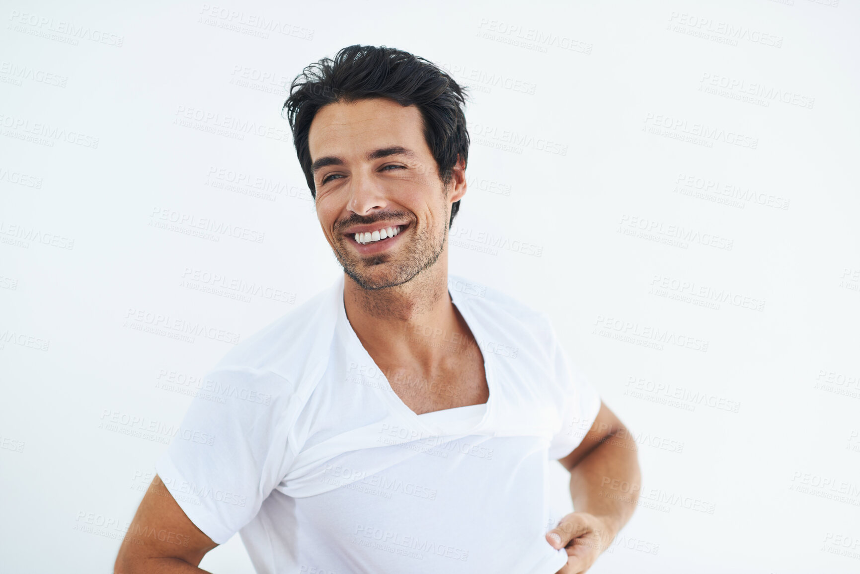 Buy stock photo Thinking, smile and a young man dressing in studio isolated on white background at the start of his morning. Idea, vision and getting ready with a happy person in a tshirt or casual clothing outfit 