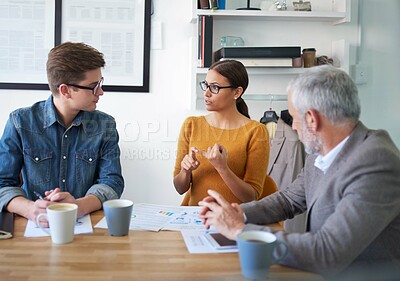 Buy stock photo Shot of a group of coworkers brainstorming during a meeting