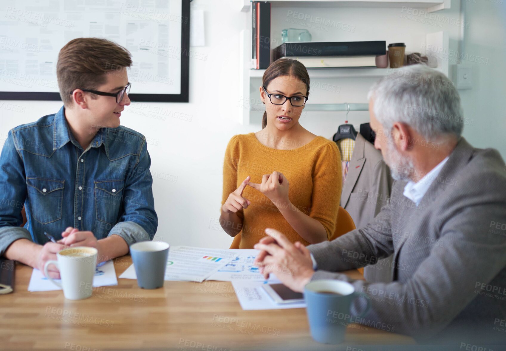 Buy stock photo Shot of a group of coworkers brainstorming during a meeting