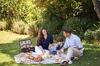 Buy stock photo Shot of a family enjoying a picnic together