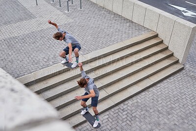Buy stock photo Shot of skateboarders in the city
