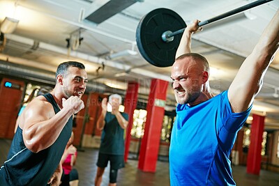 Buy stock photo Shot of a fitness instructor motivating his client during their workout session