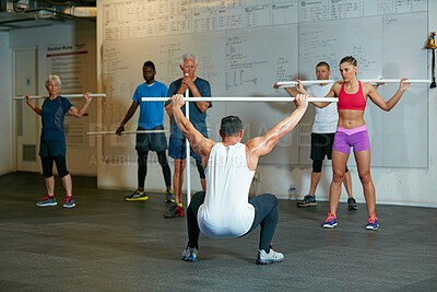 Buy stock photo Shot of a fitness group working out at the gym