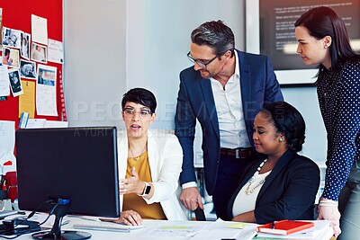 Buy stock photo Cropped shot of four business colleagues working in the office