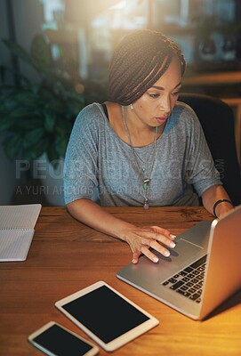 Buy stock photo Cropped shot of a young woman working late in the office