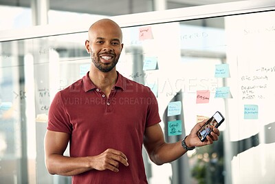 Buy stock photo Cropped shot of a young businessman holding his cellphone