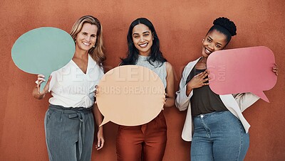 Buy stock photo Cropped portrait of a young group of businesswomen standing together and holding speech bubbles while outside