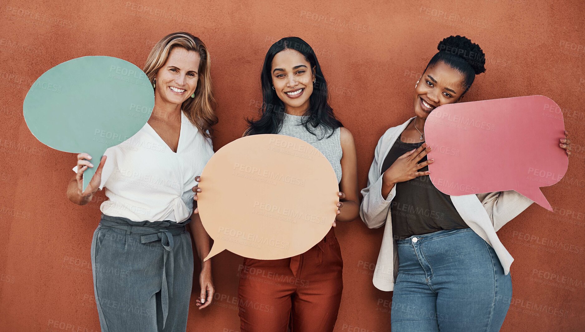 Buy stock photo Cropped portrait of a young group of businesswomen standing together and holding speech bubbles while outside