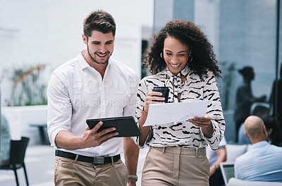 Buy stock photo Shot of a young businessman and businesswoman using a digital tablet at a conference
