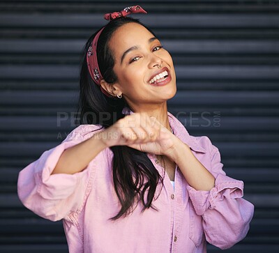 Buy stock photo Cropped portrait of an attractive young woman punching the air playfully while posing against a grey background