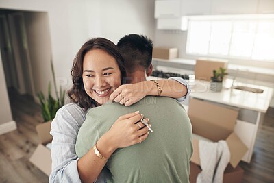 Buy stock photo Shot of a couple embracing each other while moving into their new home