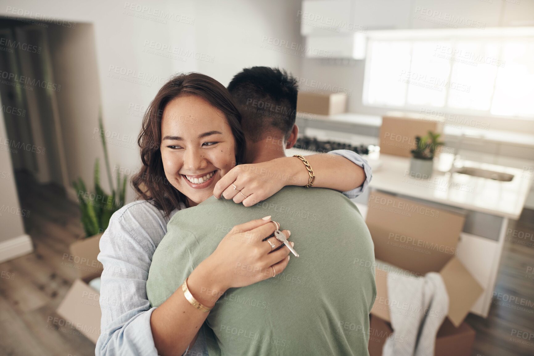 Buy stock photo Shot of a couple embracing each other while moving into their new home