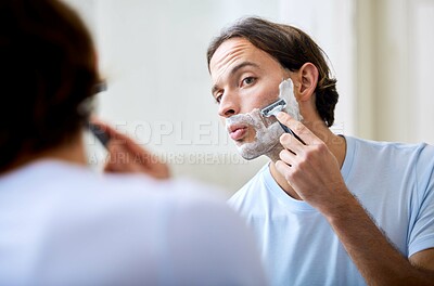 Buy stock photo Man shave face in mirror, foam and beauty with morning routine, cosmetic care and grooming at home. Male person in bathroom, hygiene and shaving cream with razor, hair removal and skincare treatment