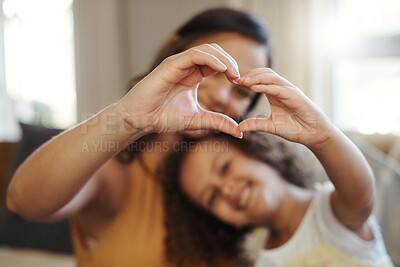 Buy stock photo Shot of an unrecognizable woman bonding with her daughter at home and making a heart-shaped gesture