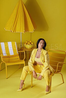 Buy stock photo Studio shot of a young woman dressed in stylish yellow clothes against a yellow background